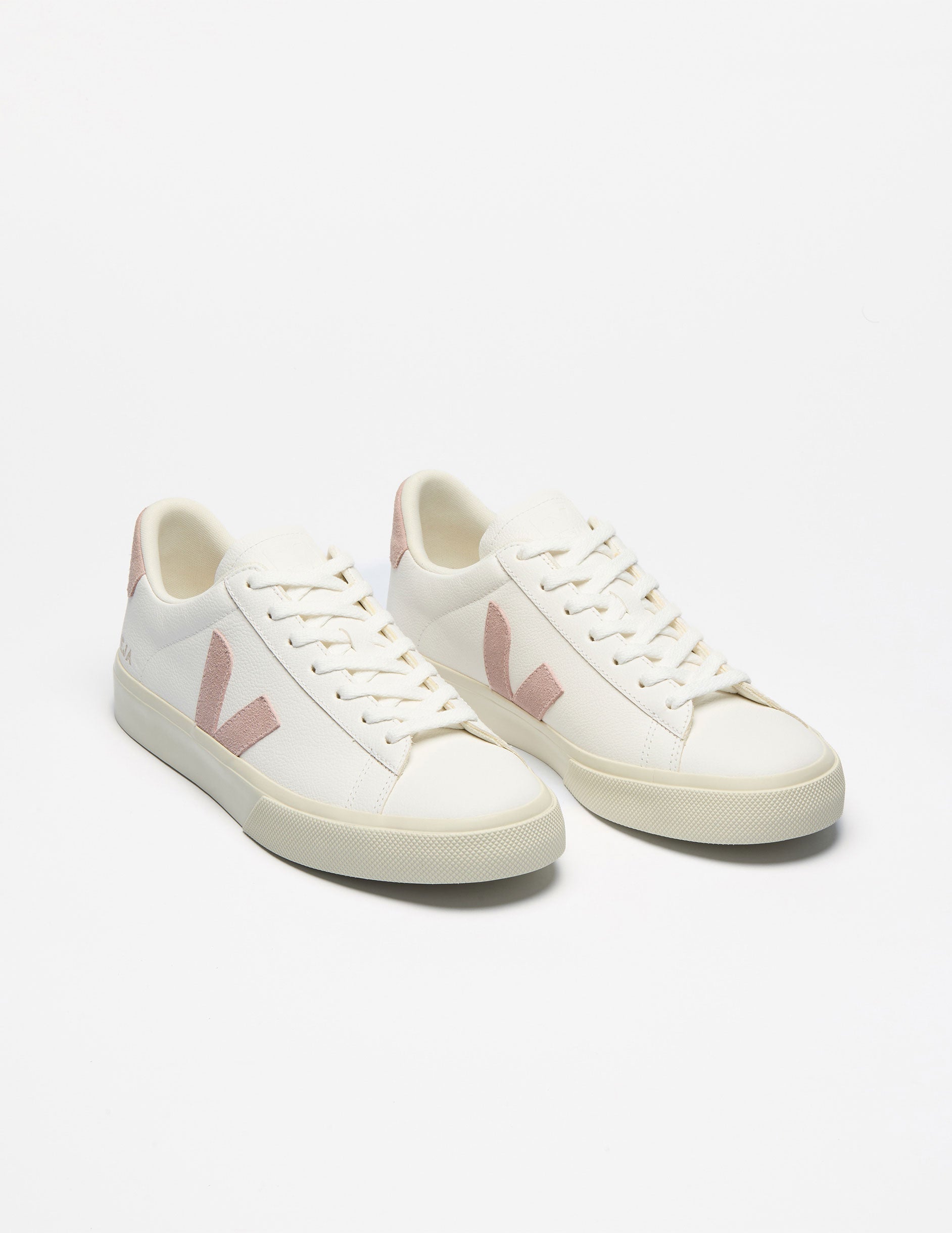 white low top VEJA sneakers with a pink logo detailing.