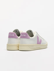 white low top VEJA sneakers with a purple logo detailing.