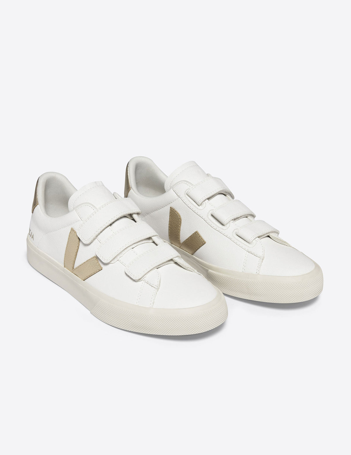 white VEJA sneakers with velcro straps.
