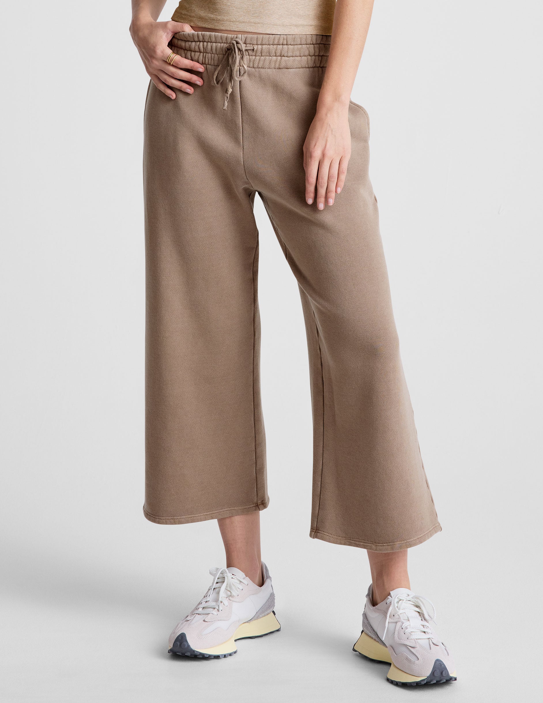 brown wide leg terry pants with a drawcord at waistband and pockets.