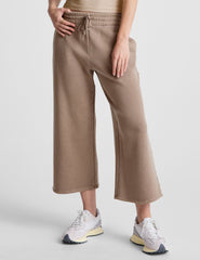 brown wide leg terry pants with a drawcord at waistband and pockets.