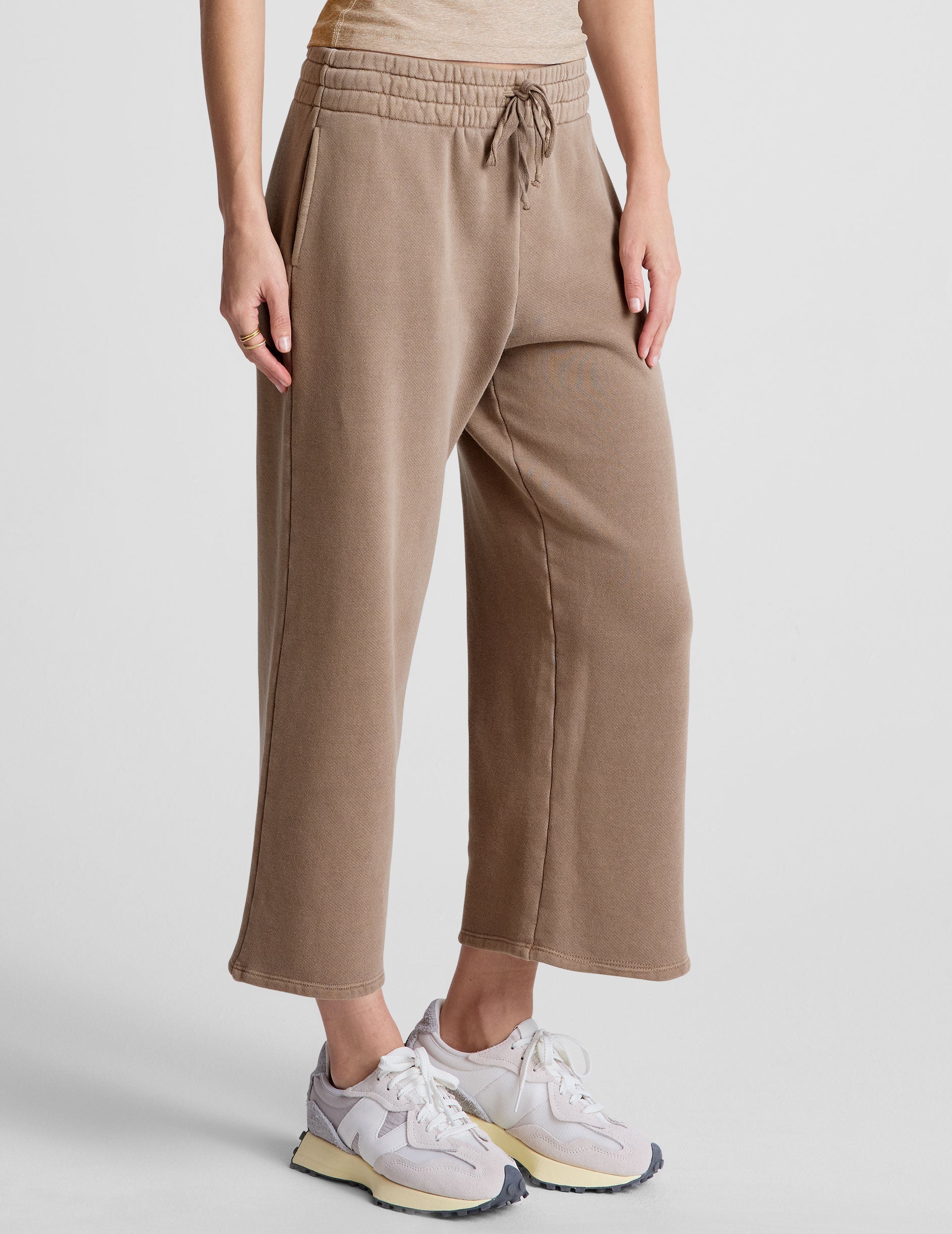 brown wide leg terry pants with a drawcord at waistband and pockets.