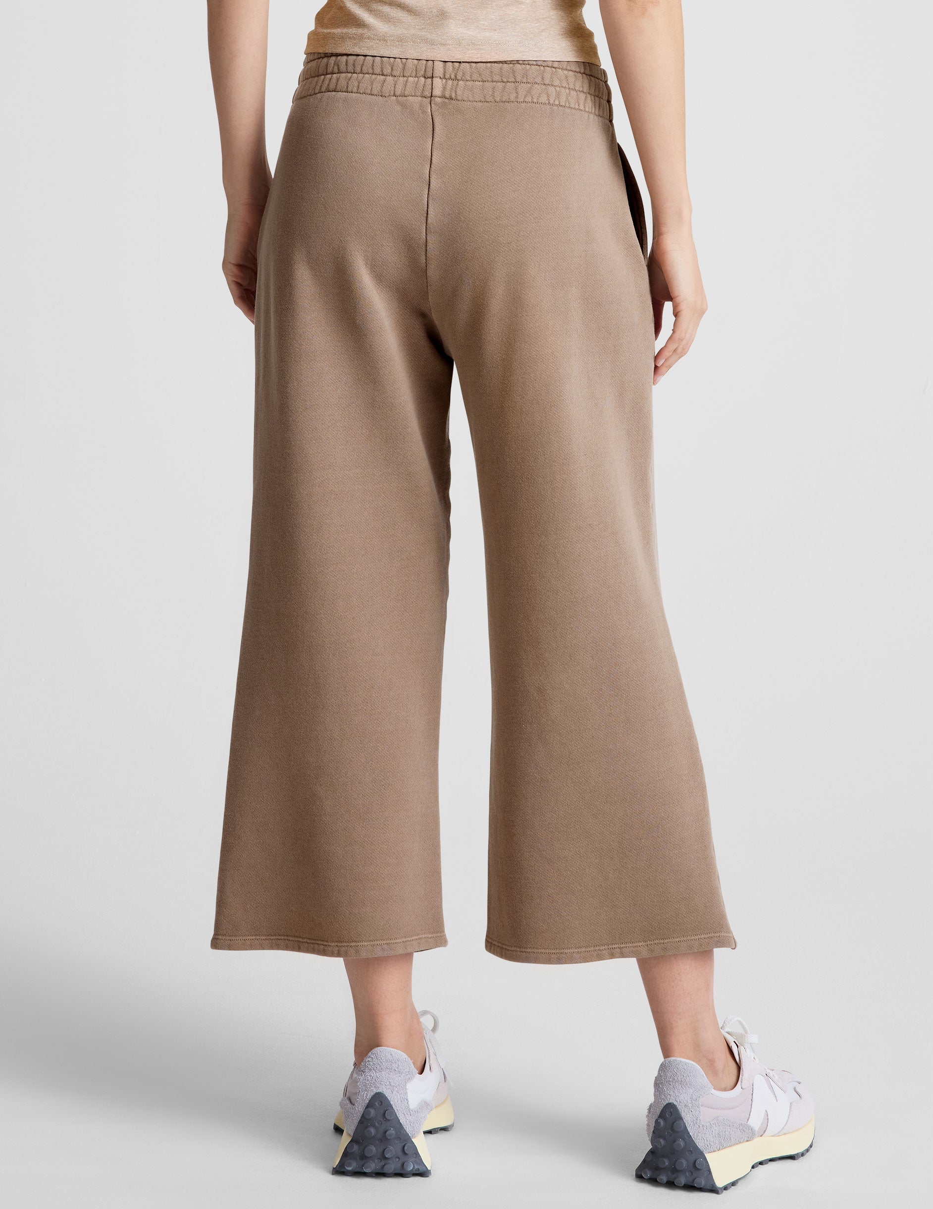 brown wide leg terry pants with a drawcord at waistband and pockets.