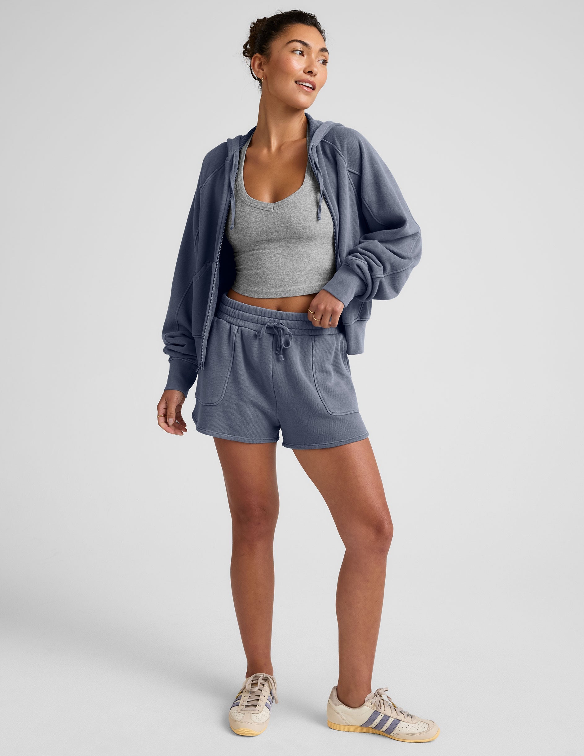 blue zip-up jacket with pockets and a hoodie.