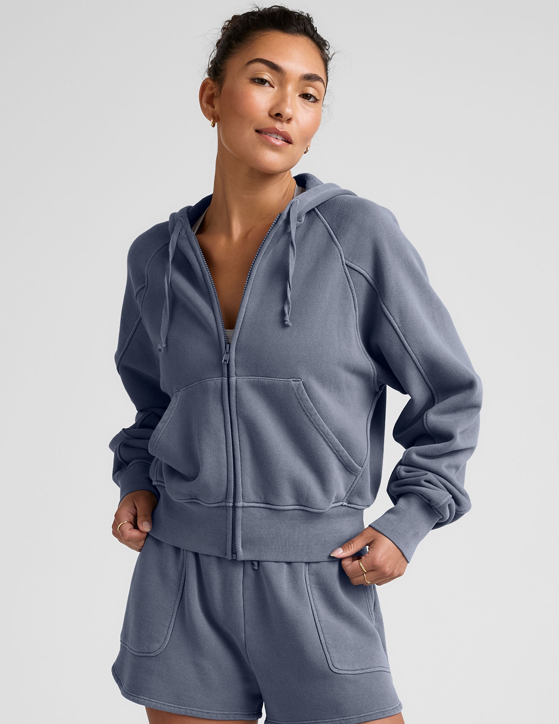 blue zip-up jacket with pockets and a hoodie.