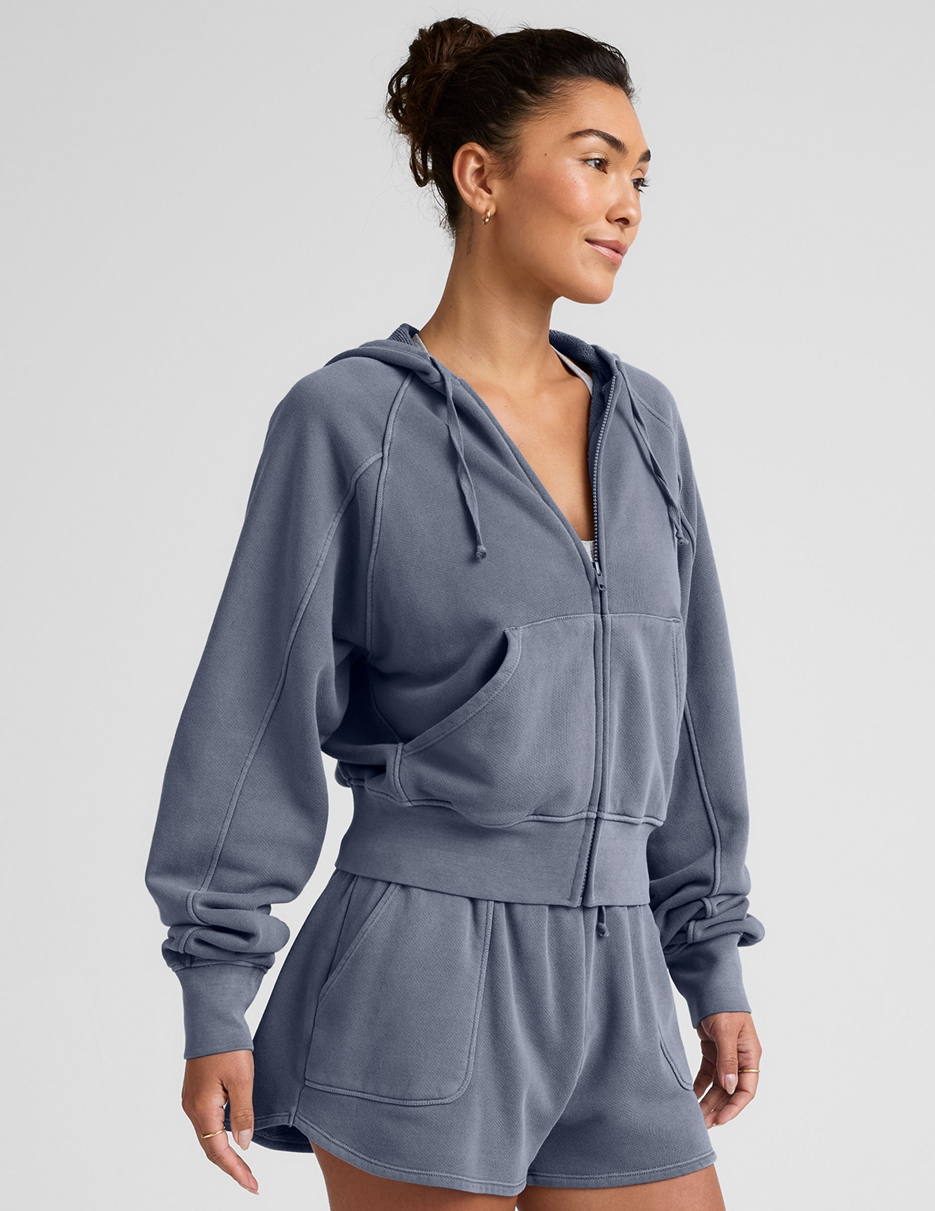 blue zip-up jacket with pockets and a hoodie.