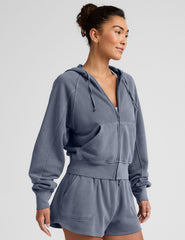 blue zip-up jacket with pockets and a hoodie.