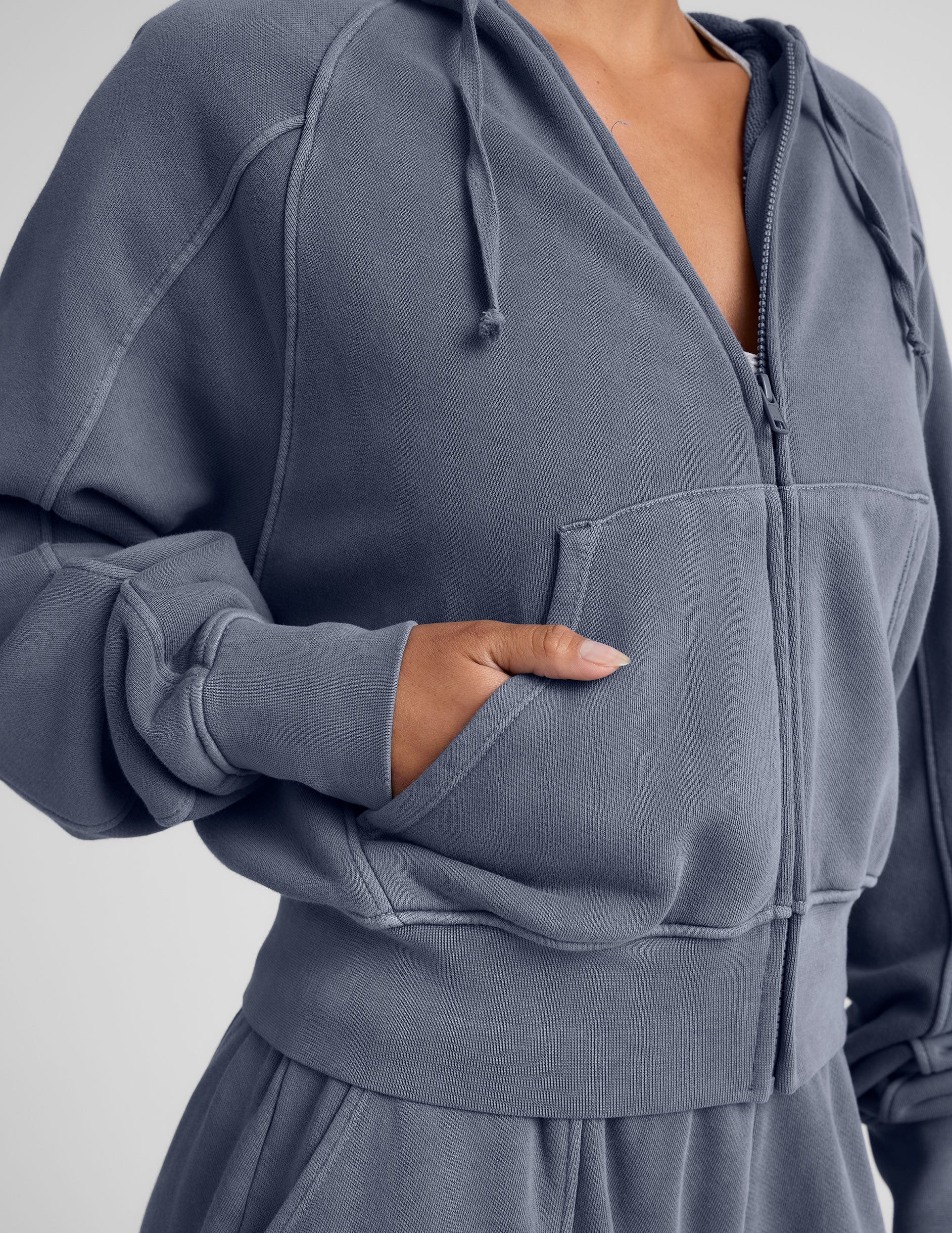 blue zip-up jacket with pockets and a hoodie.