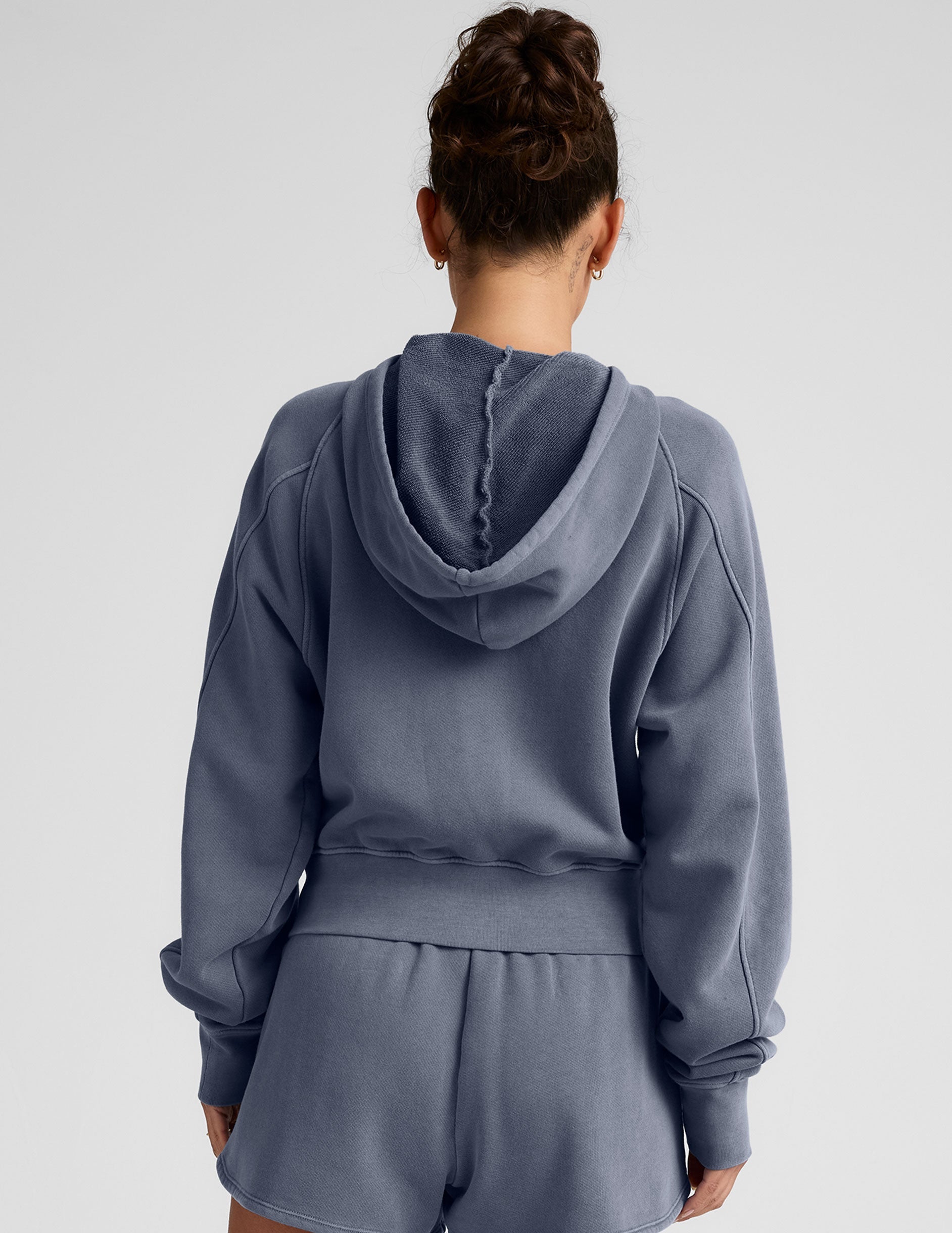 blue zip-up jacket with pockets and a hoodie.