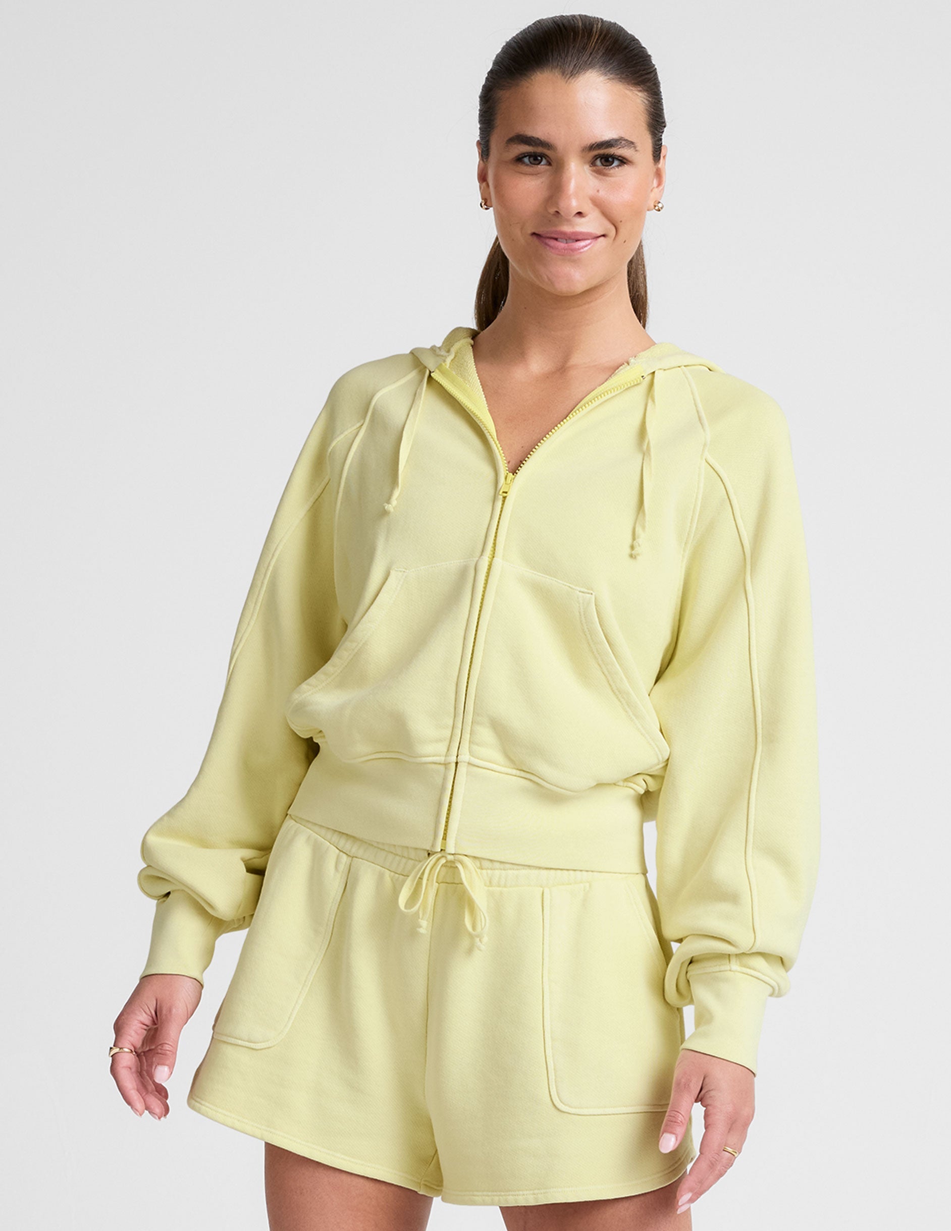 yellow zip-up sweatshirt with pockets.