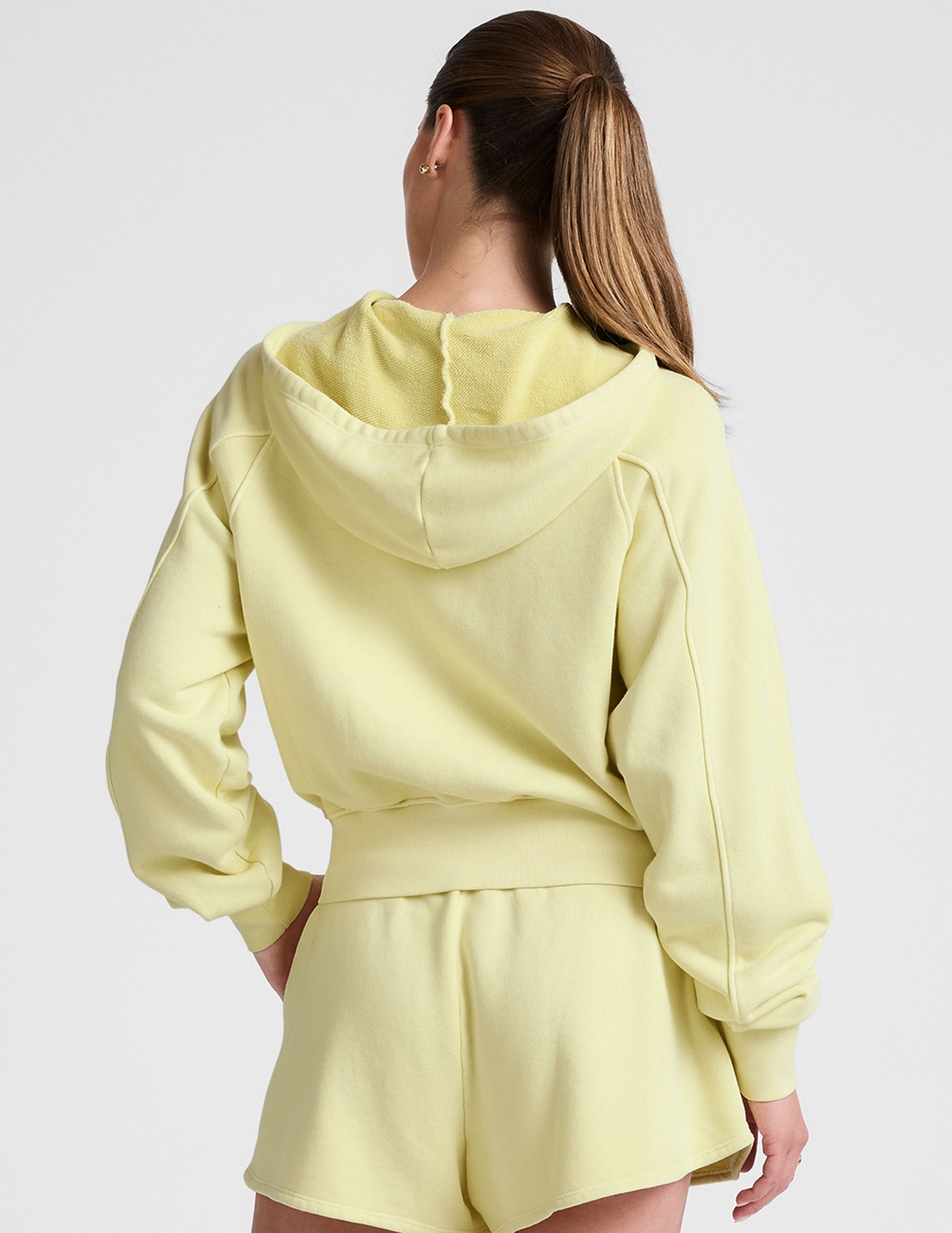 yellow zip-up sweatshirt with pockets.