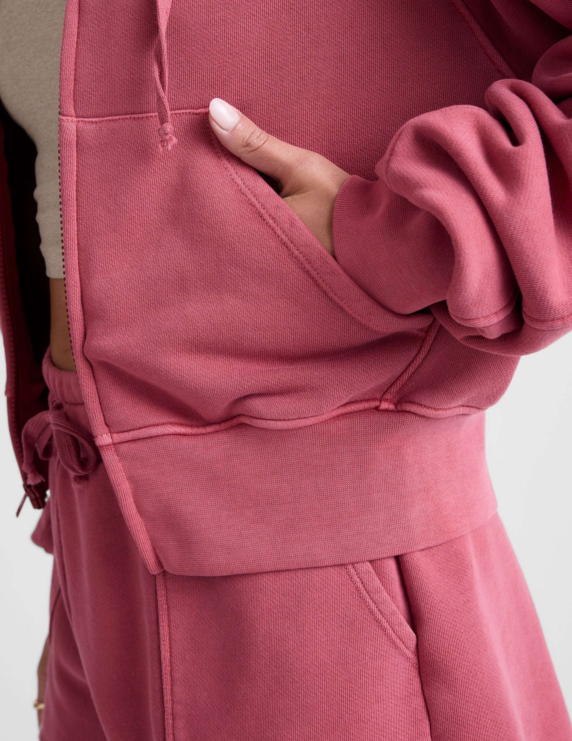 red garment dyed zip-up sweatshirt with pockets.