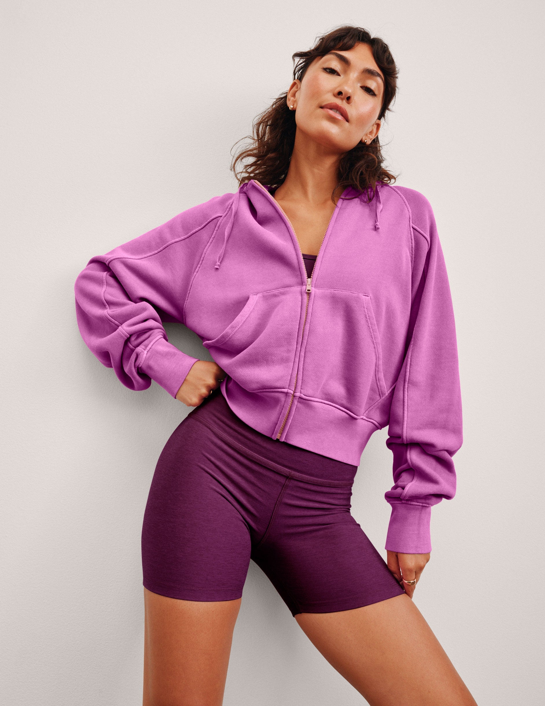 pink zip-up jacket with pockets and a hoodie.