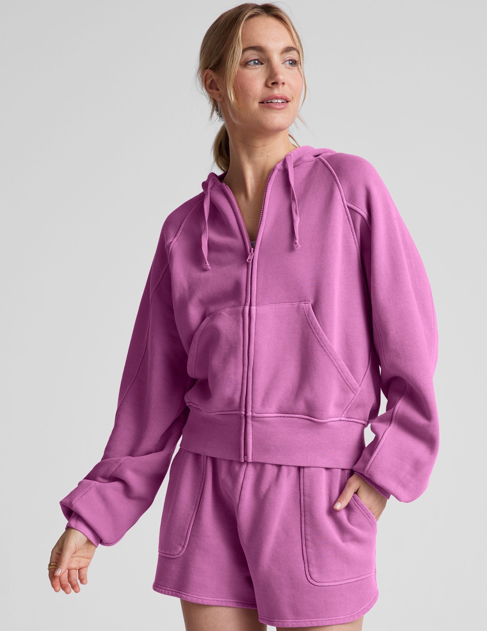 pink zip-up jacket with pockets and a hoodie.