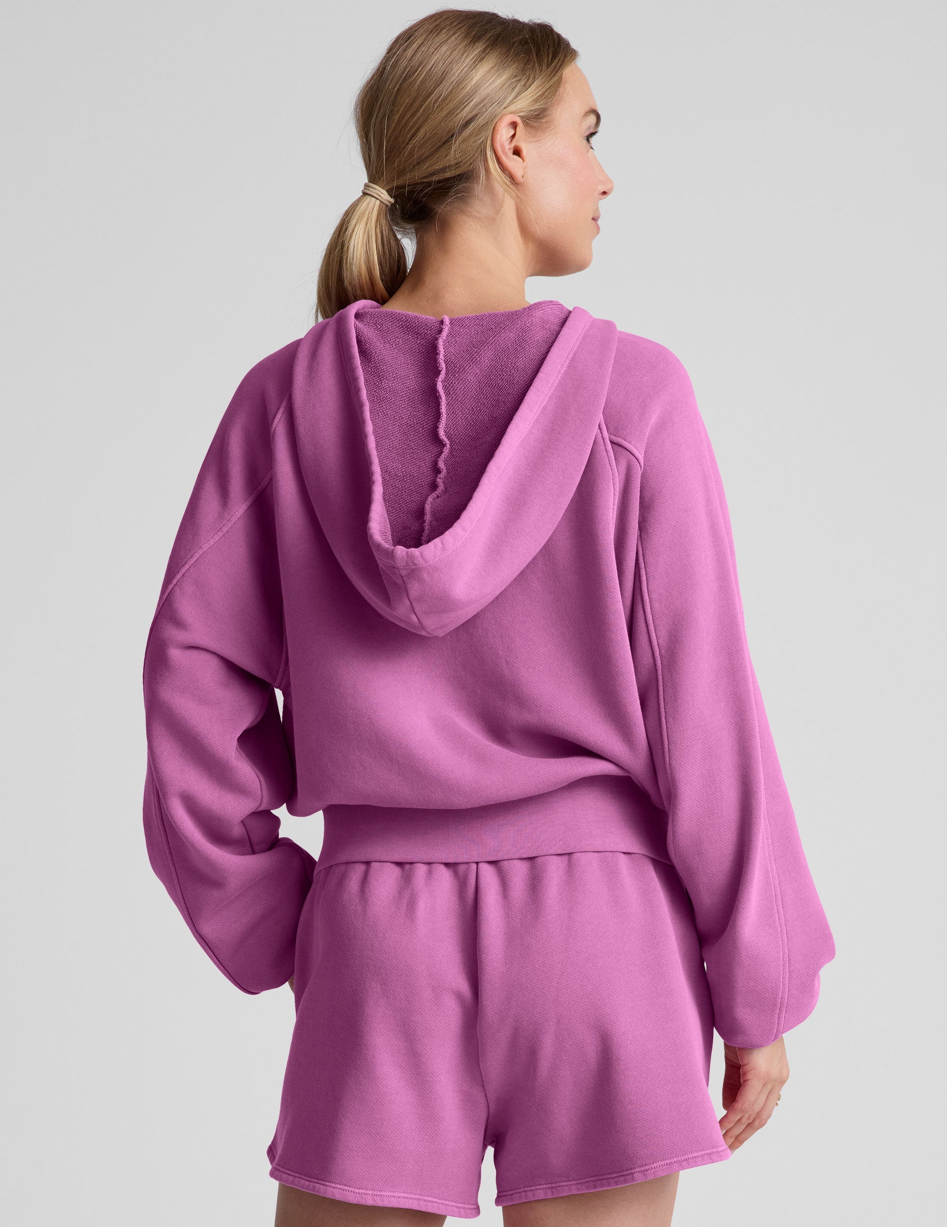 pink zip-up jacket with pockets and a hoodie.