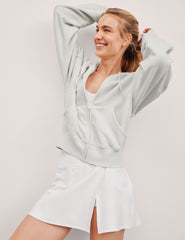 white zip-up jacket with hoodie and pockets.