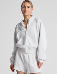 white zip-up jacket with hoodie and pockets.