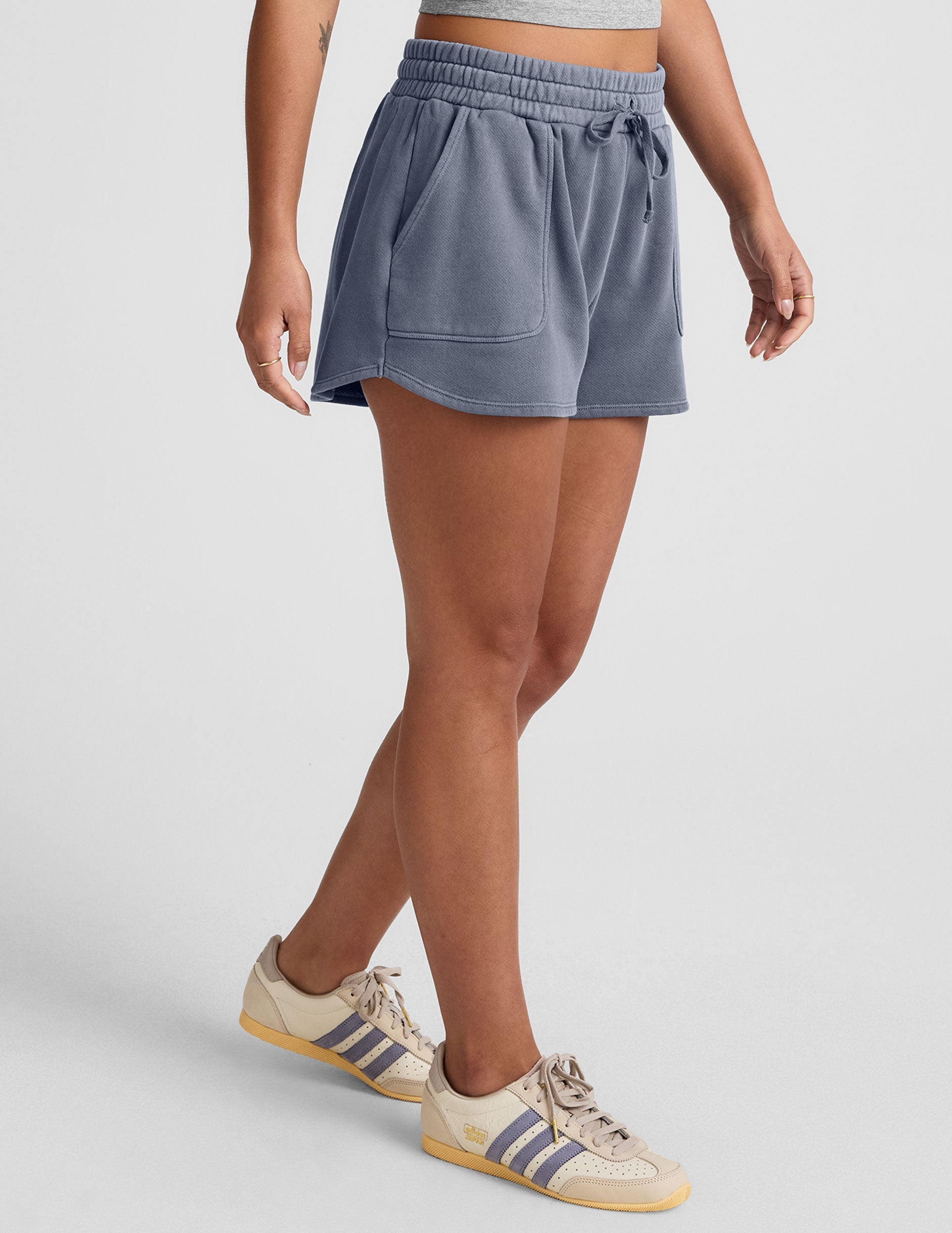 blue shorts with patch pockets and a drawstring at the waistband.