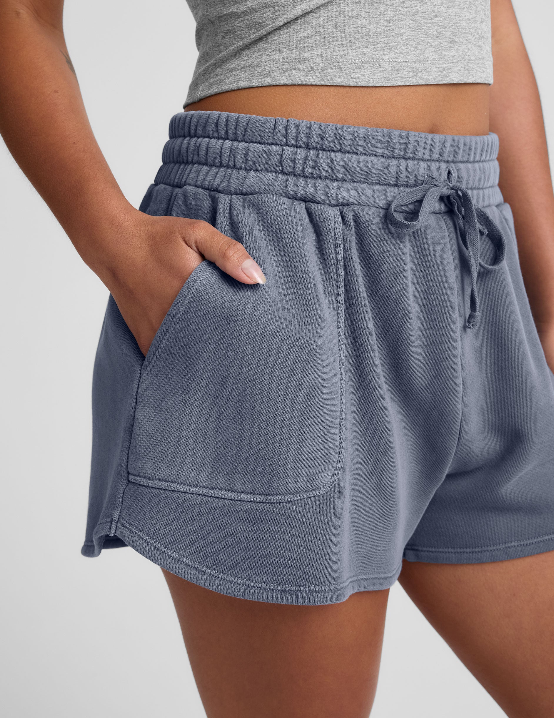 blue shorts with patch pockets and a drawstring at the waistband.