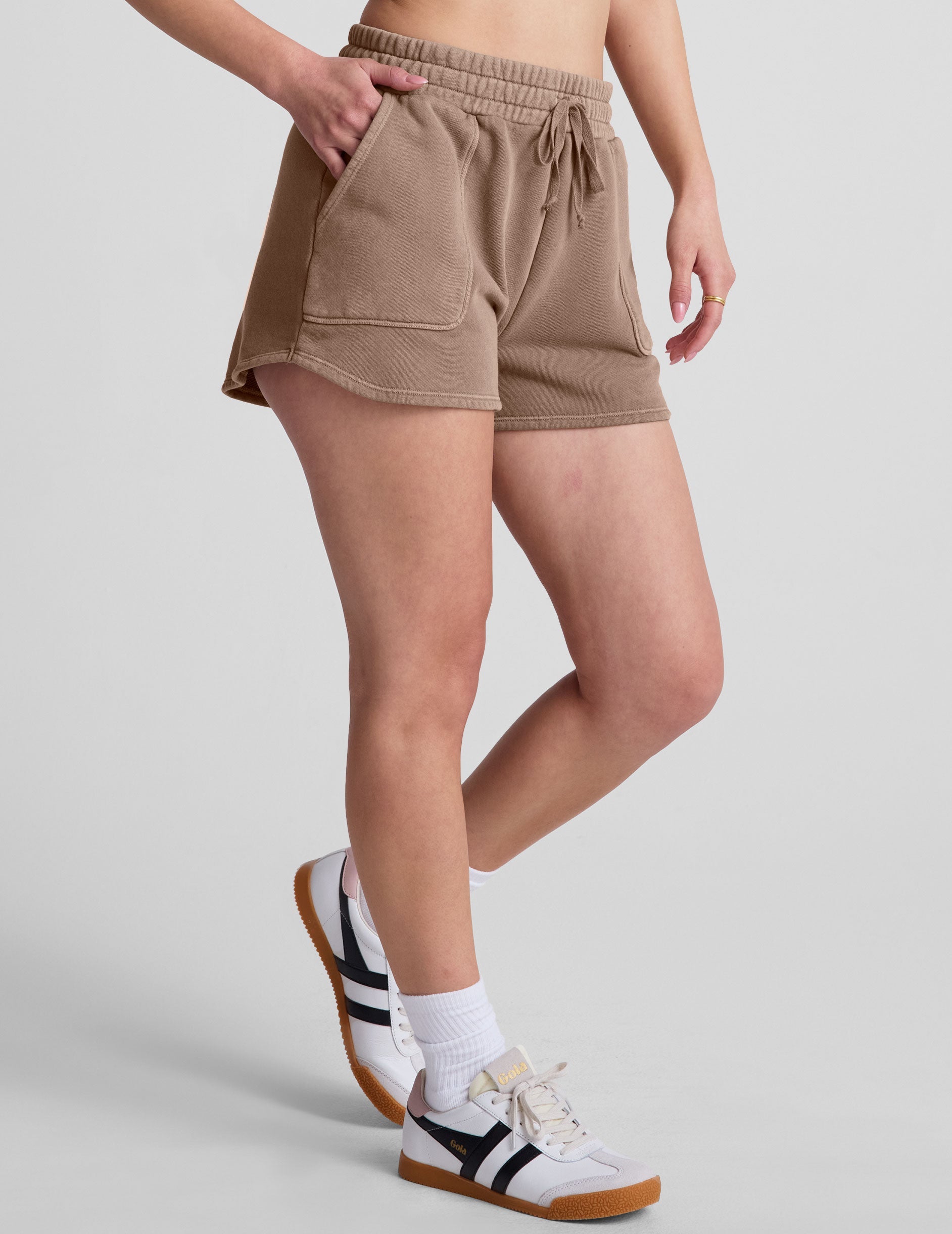 brown shorts with patch pockets and a drawstring at the waistband.