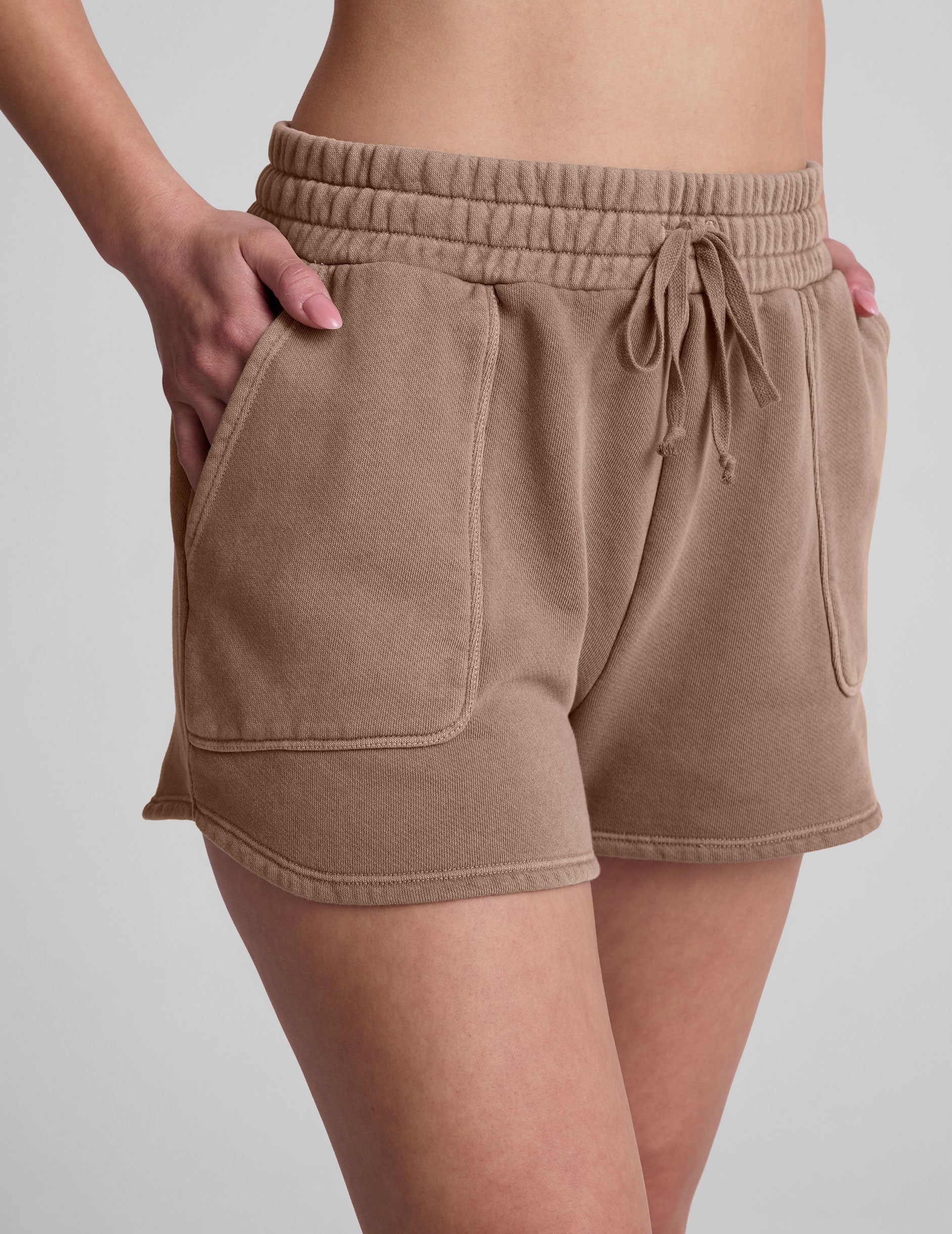 brown shorts with patch pockets and a drawstring at the waistband.