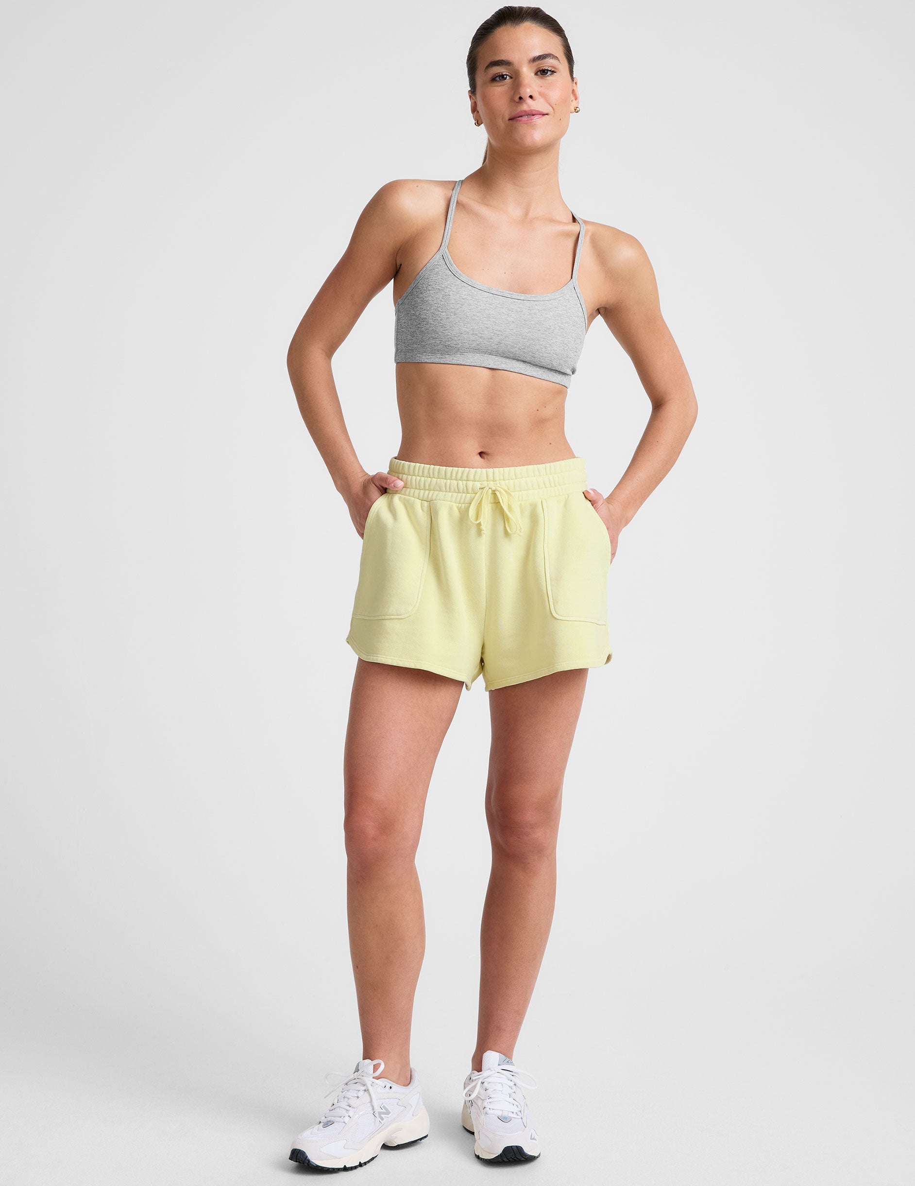 yellow terry shorts with pockets and a drawcord at waist.