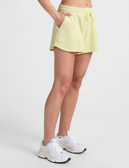 yellow terry shorts with pockets and a drawcord at waist.