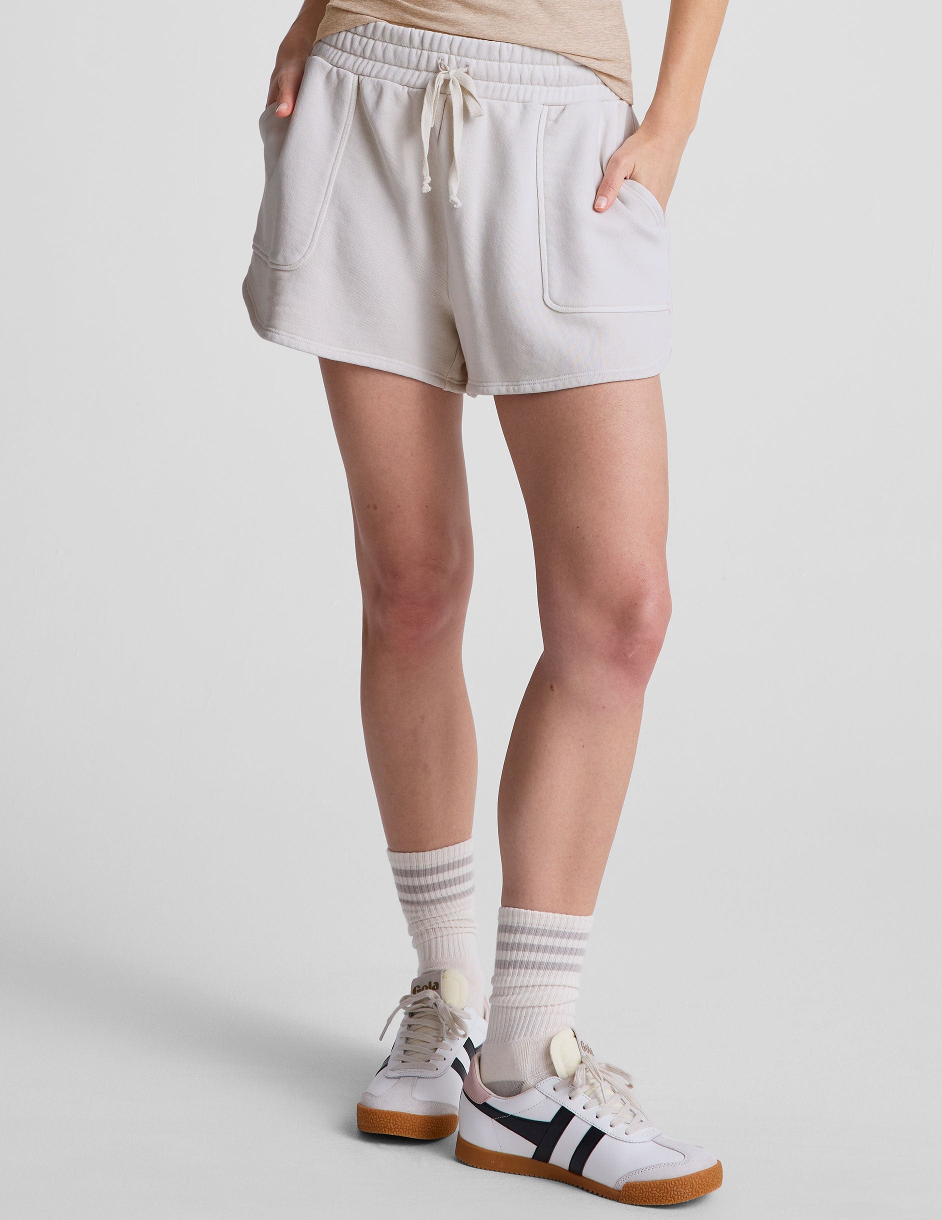 white relaxed fit terry shorts with patch pockets.