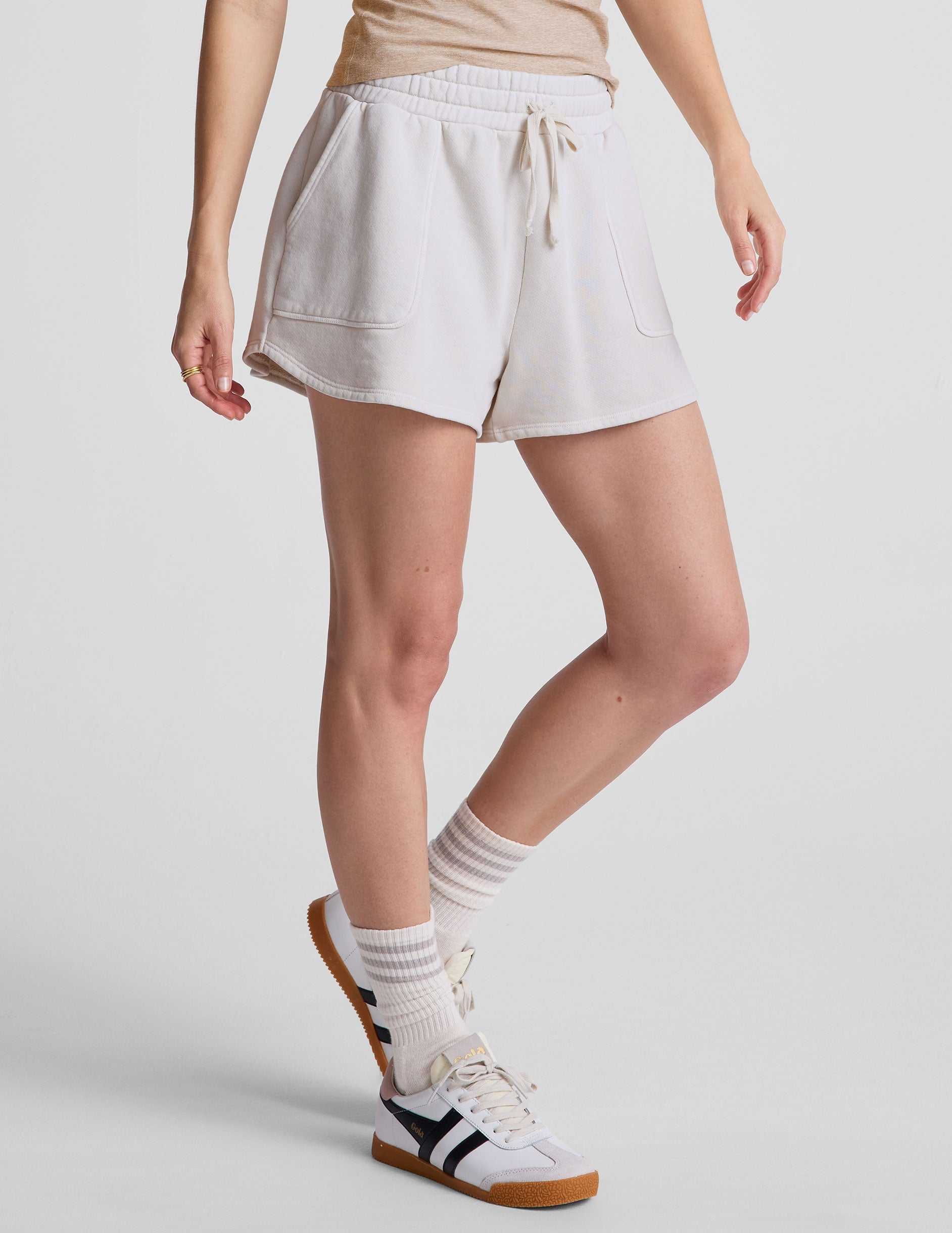 white relaxed fit terry shorts with patch pockets.