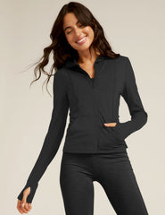 black zip-up jacket with a hoodie and thumb holes.