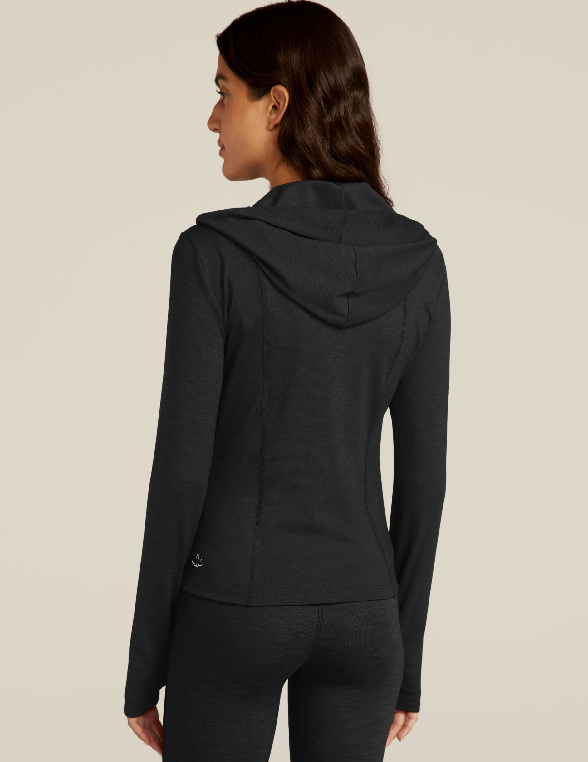 black zip-up jacket with a hoodie and thumb holes.