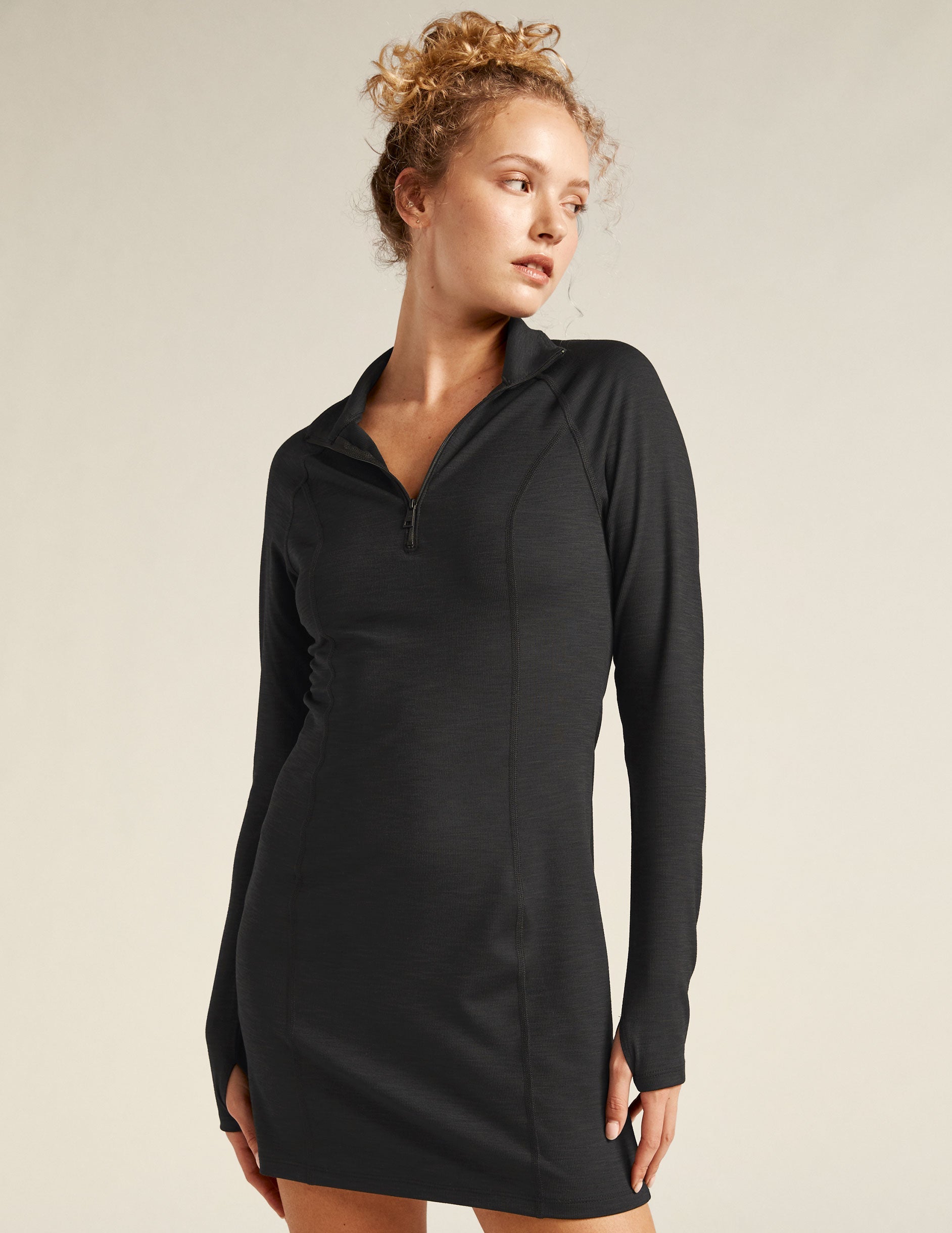 black midi dress with quarter-zup neckline.