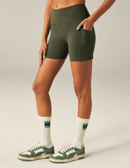 green biker shorts with pockets at sides