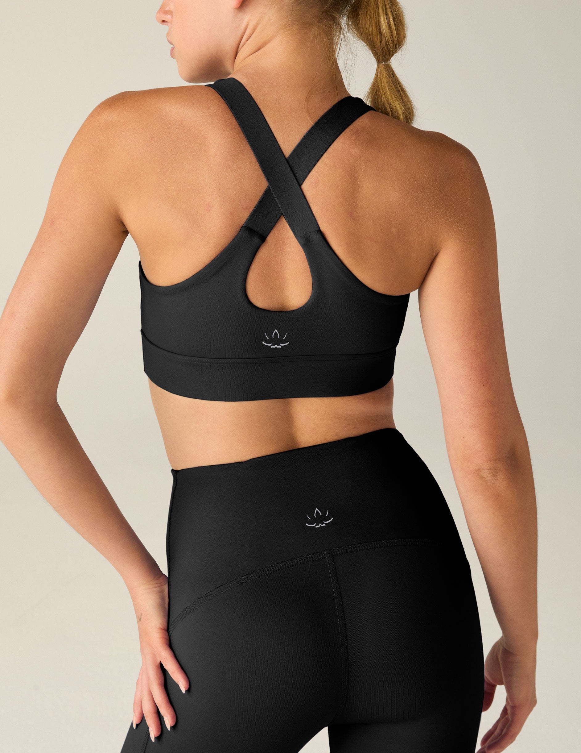 black scoop neck bra with crossover back detail.