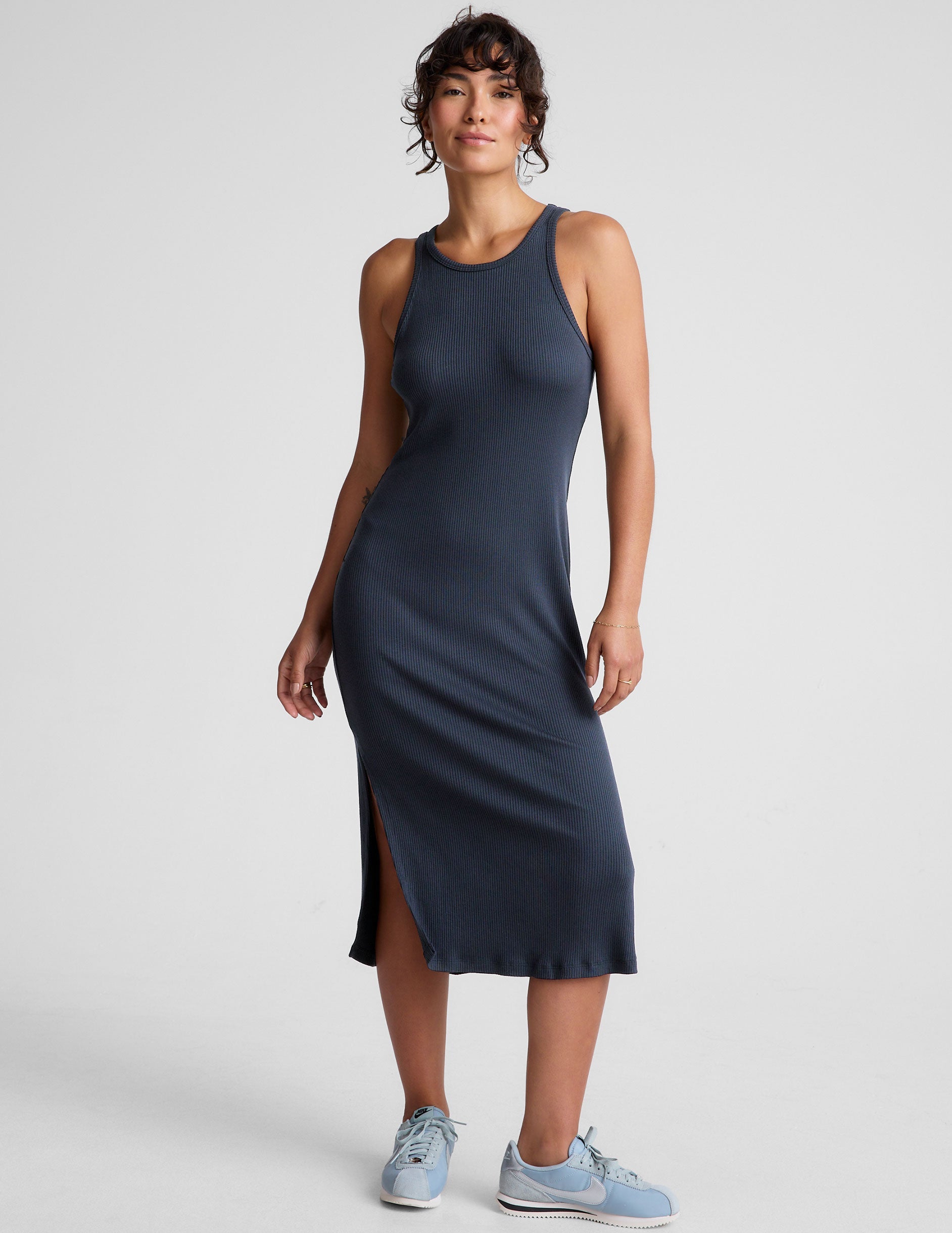 blue ribbed midi length dress with a high scoop neckline and side slit.
