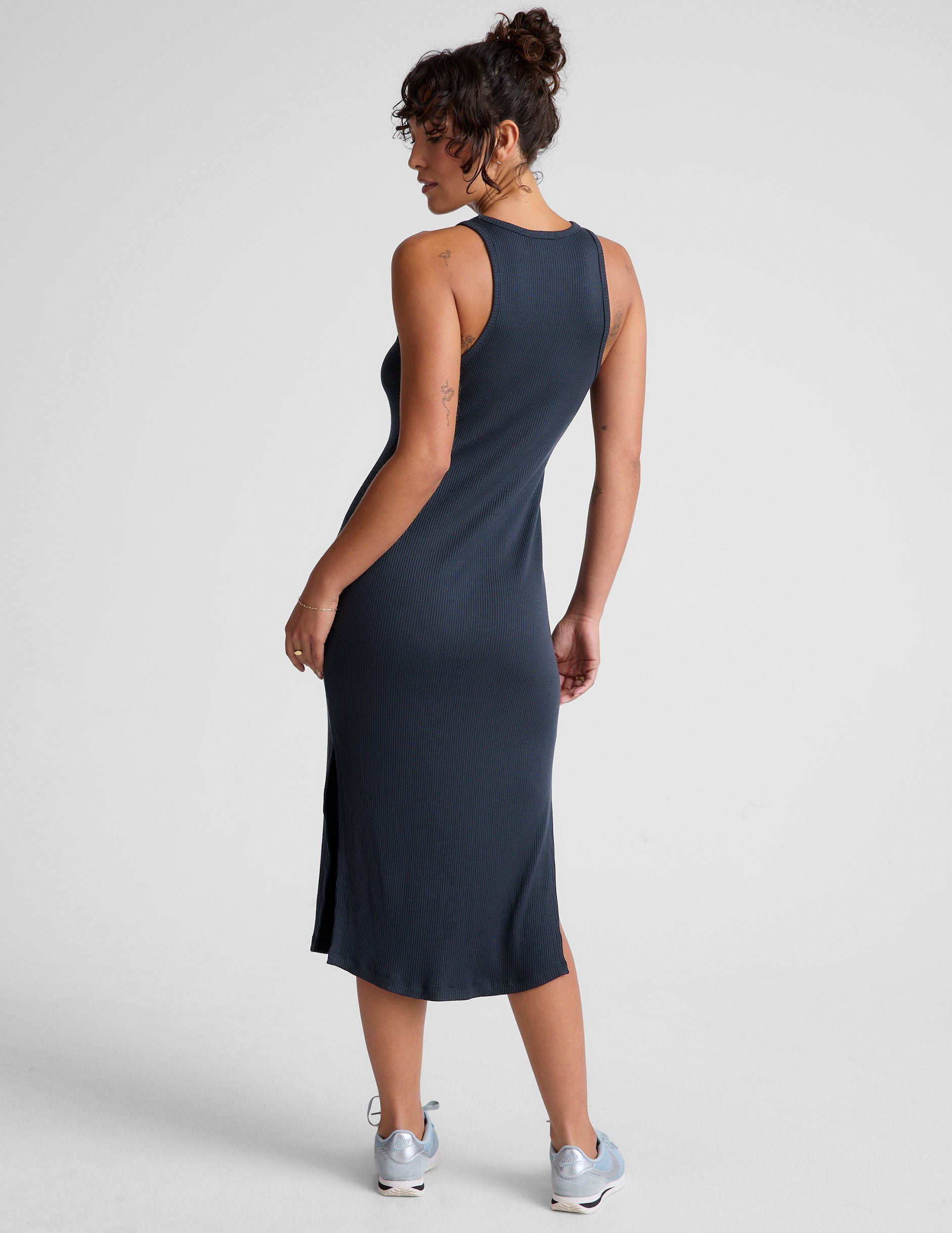 blue ribbed midi length dress with a high scoop neckline and side slit.