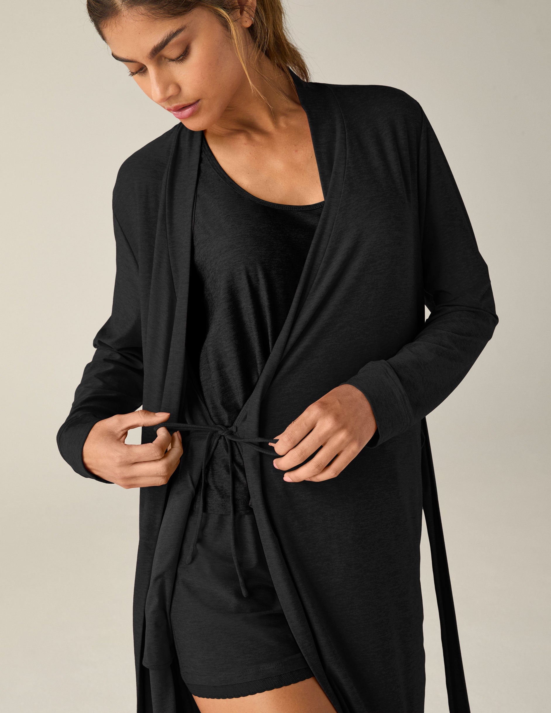 black sleep robe with a tie at the waist and side pockets.