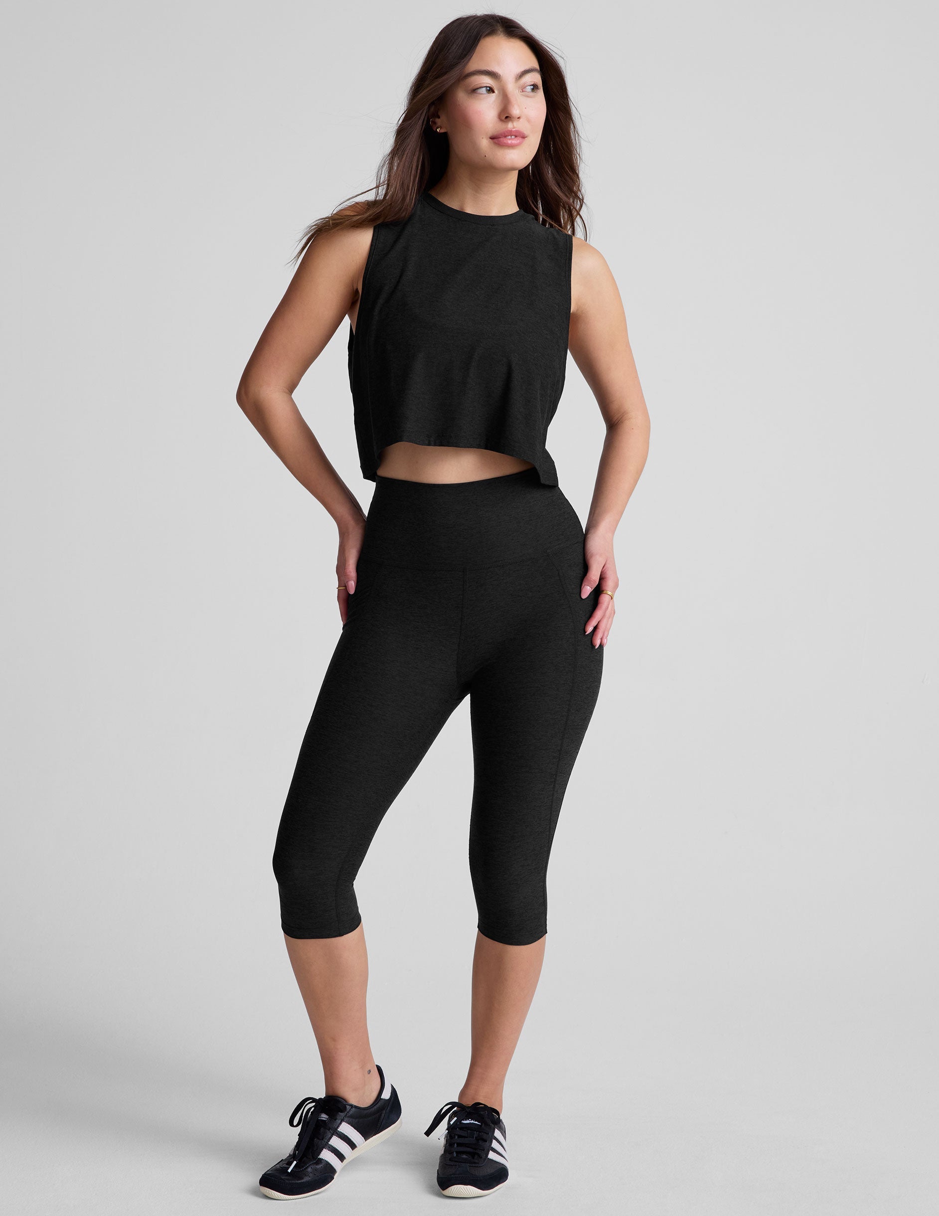 black relaxed fit and cropped tank top with a ribbed scooped neckline and ribbed arm holes.