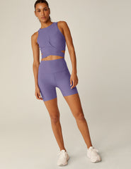 purple high-neck cropped tank top with a crossover detail in the front.