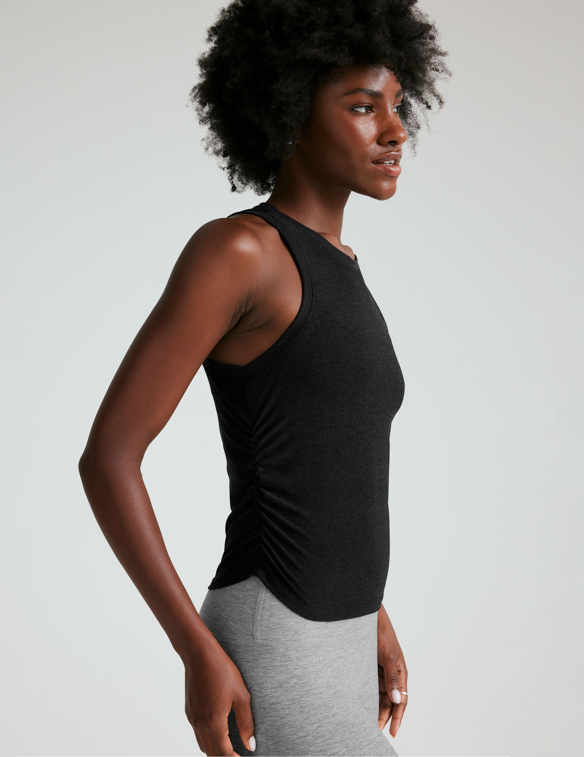 black scoop neck tank top with shirring details down the sides.