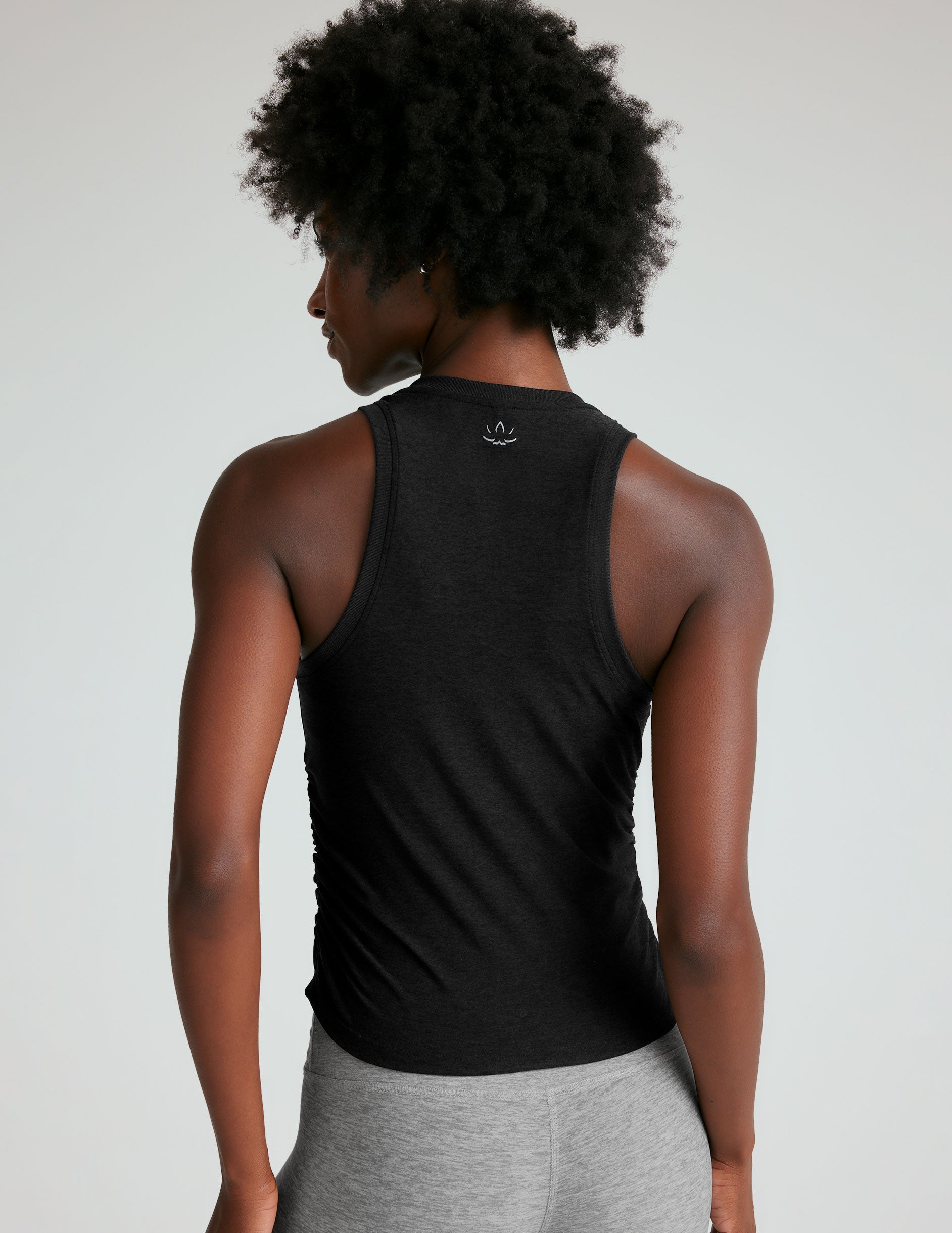 black scoop neck tank top with shirring details down the sides.