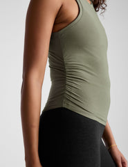 green scoop neck tank top with shirred detailing on the sides.