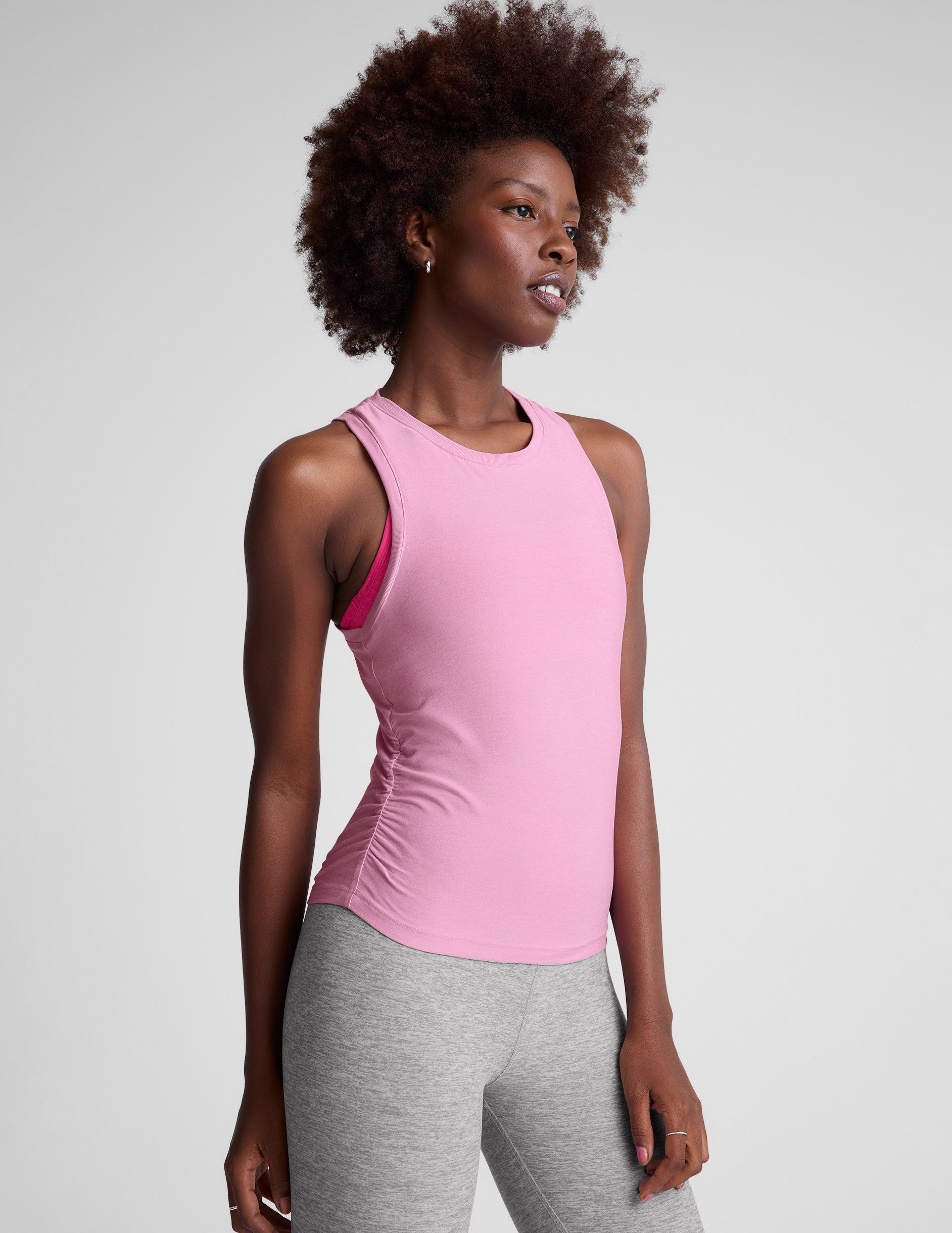 pink scoop neck tank top with shirred detailing on the sides.