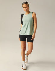 green high-neck tank top with a twist cutout detail on the back straps.