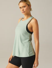 green high-neck tank top with a twist cutout detail on the back straps.