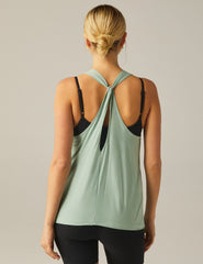 green high-neck tank top with a twist cutout detail on the back straps.