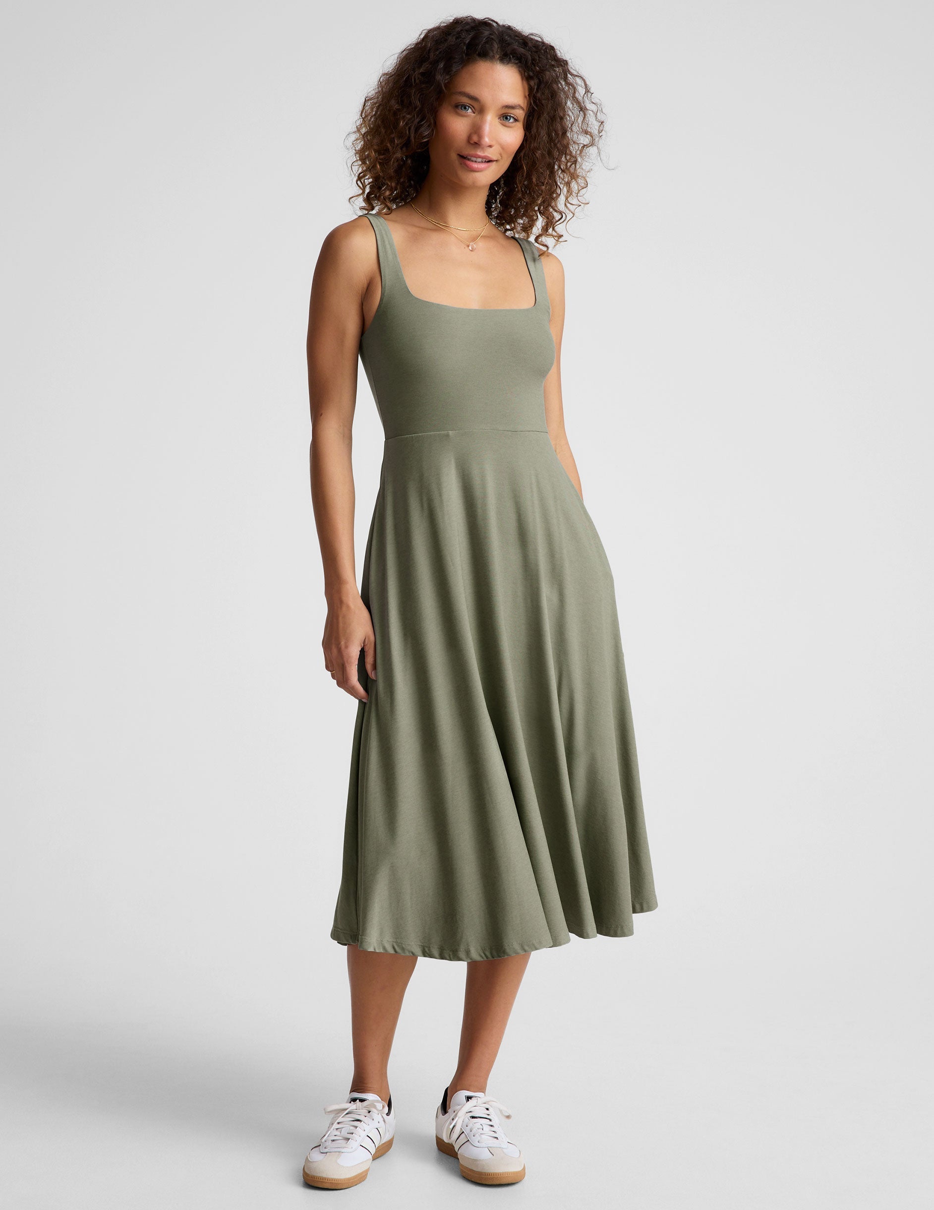 green midi length square neck dress with pockets.