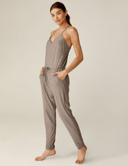 brown midi jumpsuit with a drawstring at waistband and lace trim detailing.