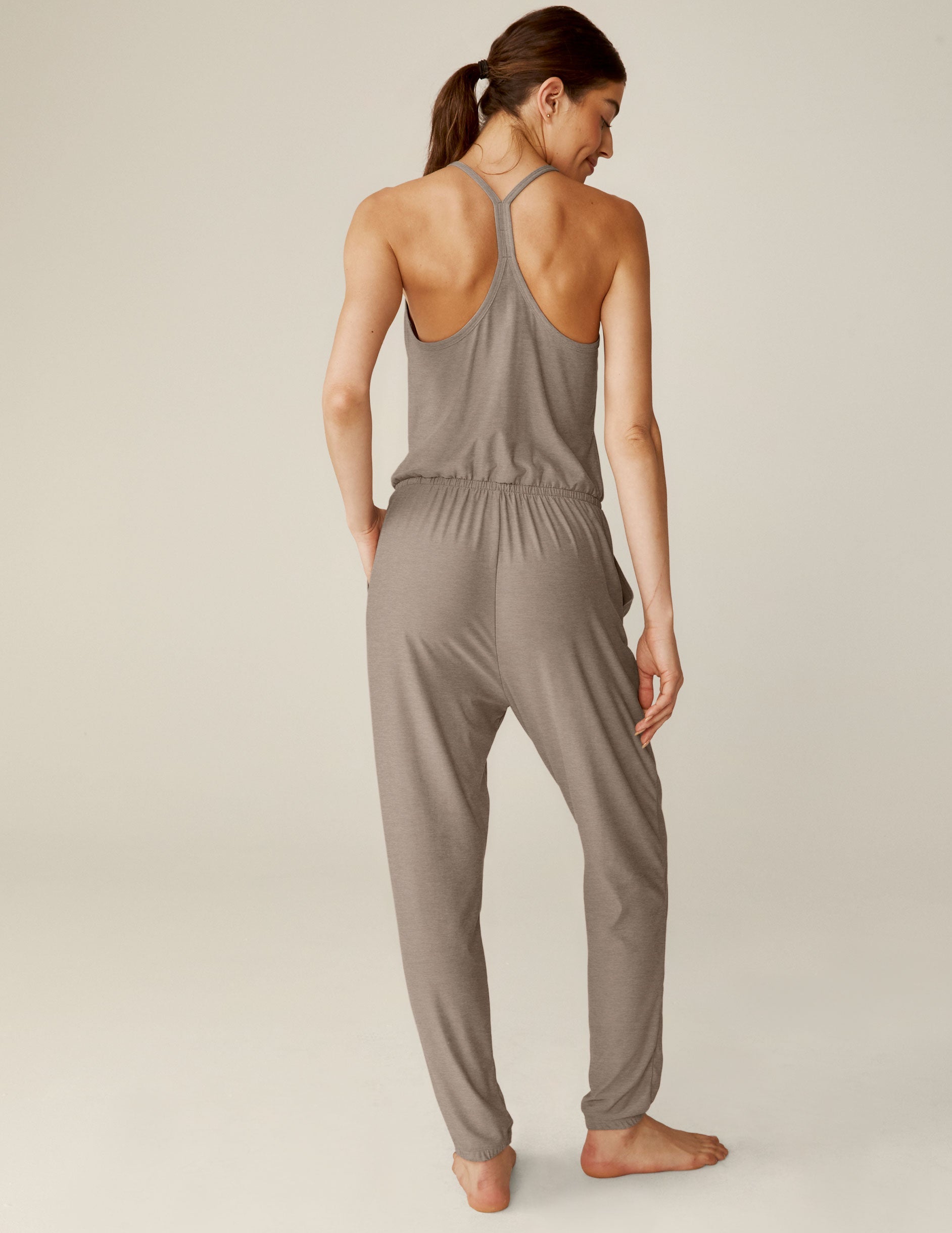 brown midi jumpsuit with a drawstring at waistband and lace trim detailing.