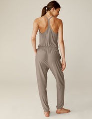 brown midi jumpsuit with a drawstring at waistband and lace trim detailing.